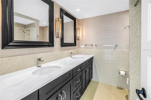 a bathroom with a sink double vanity and a mirror