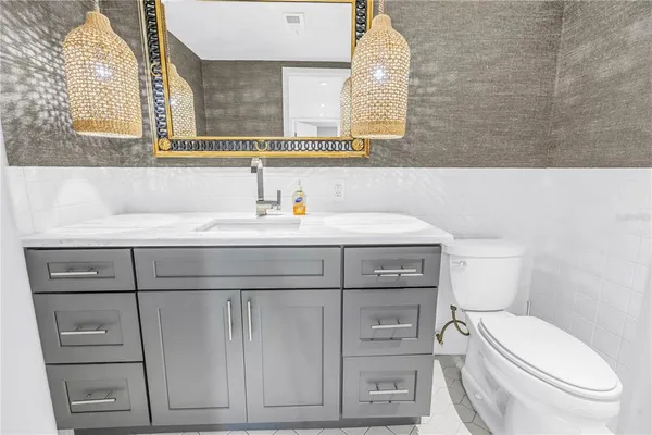 a bathroom with a sink a toilet and mirror