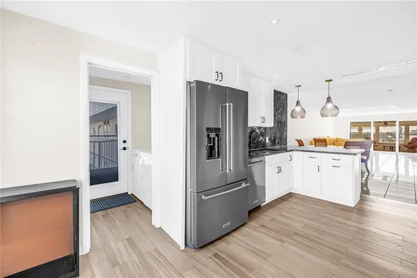 a kitchen with white cabinets and stainless steel appliances
