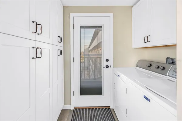 a view of a hallway with washer and dryer