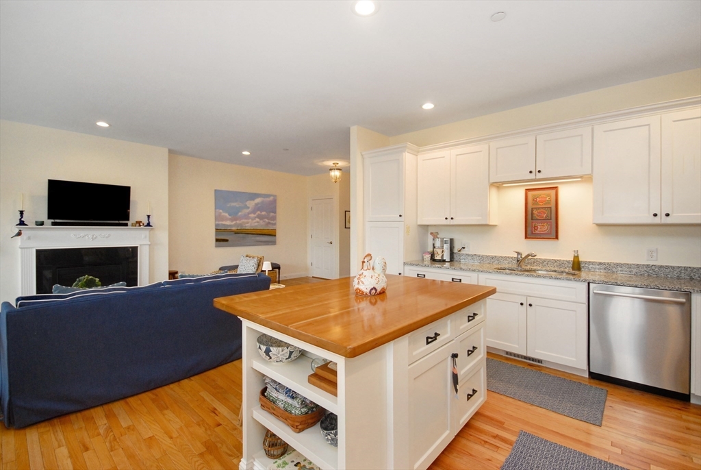 22 B Blacksmith Row, Unit B Groton, MA 01450 - Photo 13 of 24 a kitchen with a sink stove and cabinets