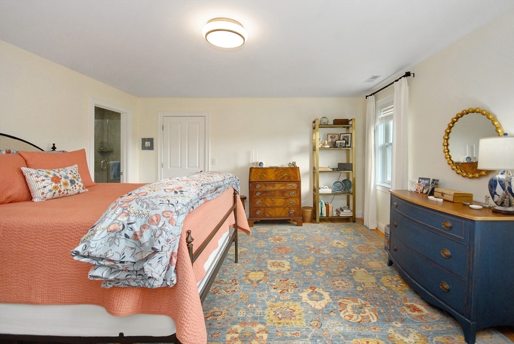 22 B Blacksmith Row, Unit B Groton, MA 01450 - Photo 17 of 24 a bedroom with a bed and dresser