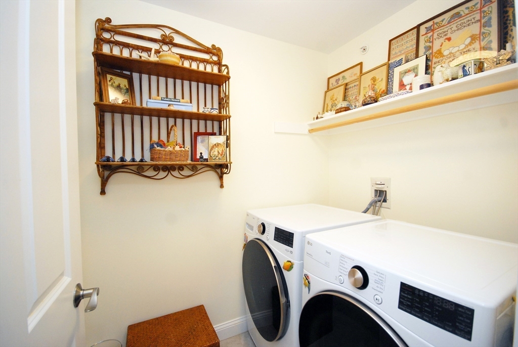 22 B Blacksmith Row, Unit B Groton, MA 01450 - Photo 20 of 24 a utility room with dryer and washer