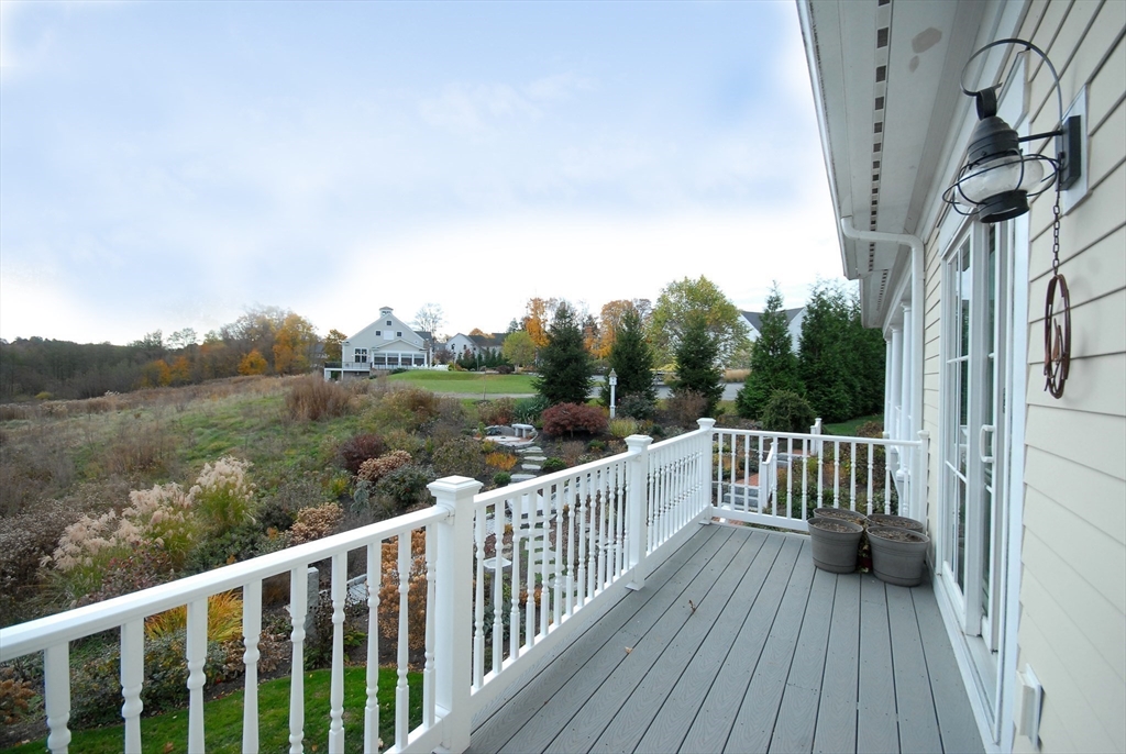 22 B Blacksmith Row, Unit B Groton, MA 01450 - Photo 24 of 24 a view of a wooden deck with a yard