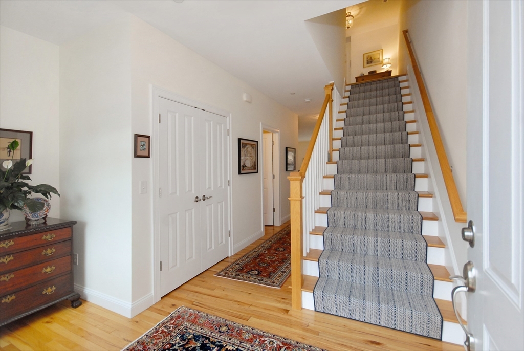 22 B Blacksmith Row, Unit B Groton, MA 01450 - Photo 5 of 24 a view of an entryway with staircase