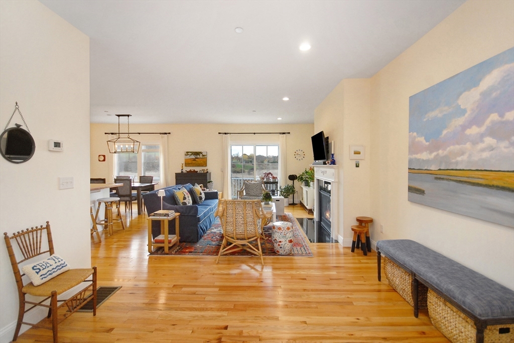 22 B Blacksmith Row, Unit B Groton, MA 01450 - Photo 6 of 24 a view of a living room with furniture and floor to ceiling window