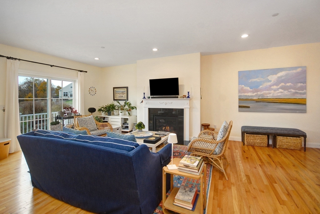 22 B Blacksmith Row, Unit B Groton, MA 01450 - Photo 8 of 24 a living room with furniture and a flat screen tv