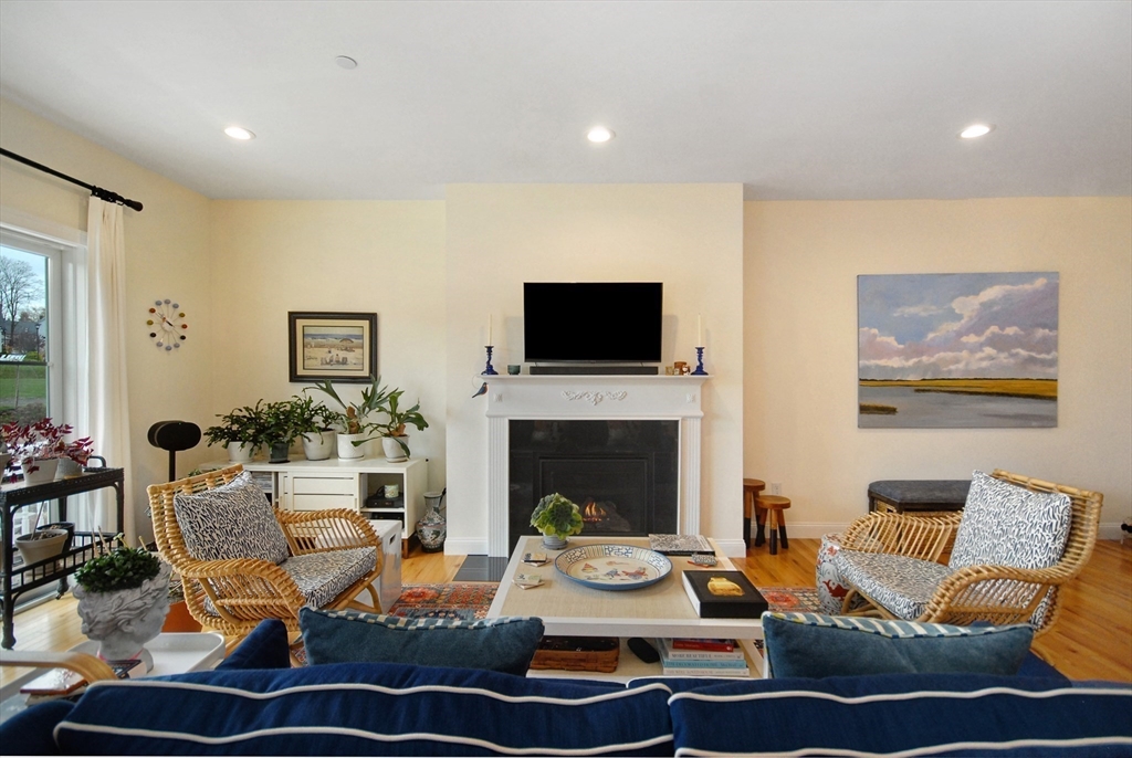 22 B Blacksmith Row, Unit B Groton, MA 01450 - Photo 9 of 24 a living room with furniture and a fireplace