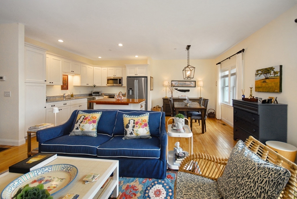22 B Blacksmith Row, Unit B Groton, MA 01450 - Photo 10 of 24 a living room with stainless steel appliances furniture and a kitchen view