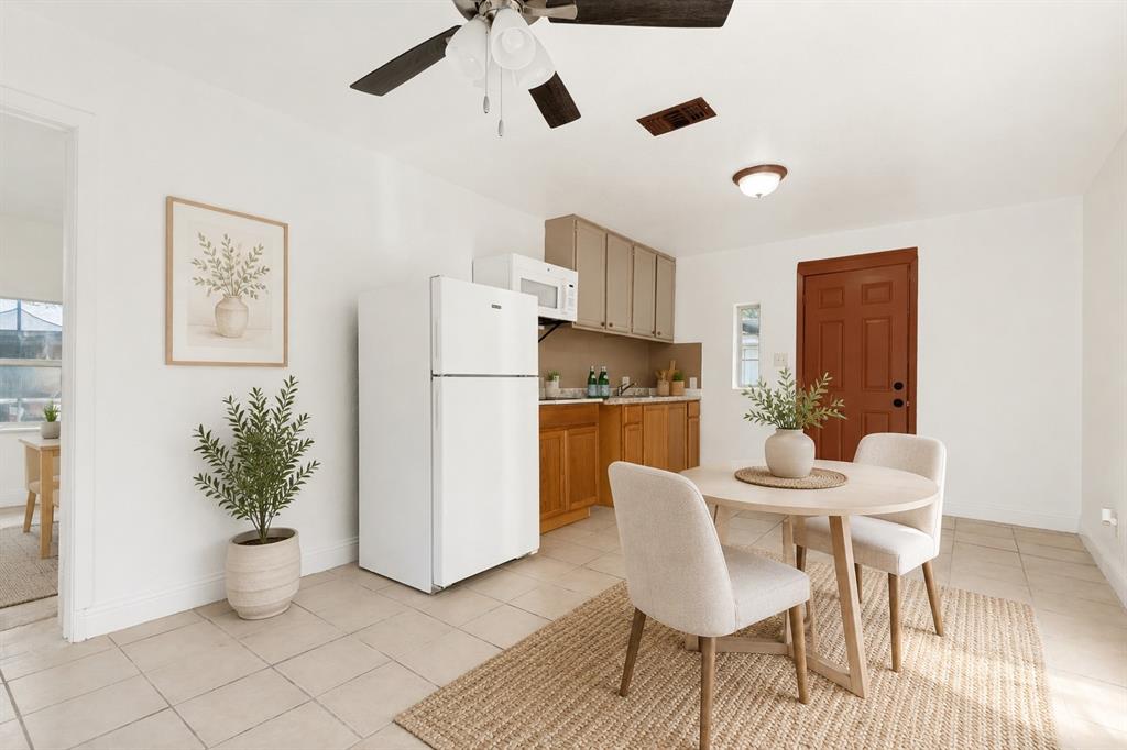 403 North Britain Road, Unit 407B Irving, TX 75061 - Photo 9 of 11 Kitchenette featuring ceramic tile flooring, a ceiling fan, wood-finish lower cabinetry, and light-toned upper cabinetry