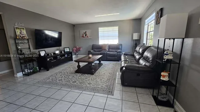 a living room with furniture and a flat screen tv