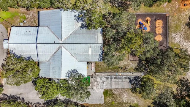 a view of street with flower plants and wooden fence
