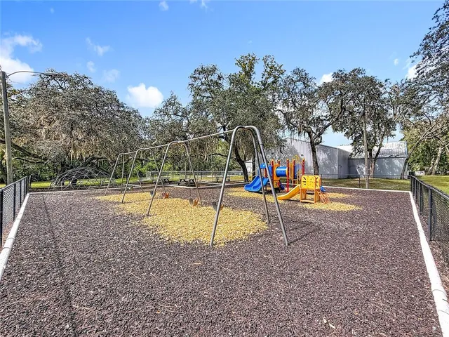 a view of a park with swings and slides