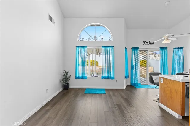 a view of room with wooden floor and large window