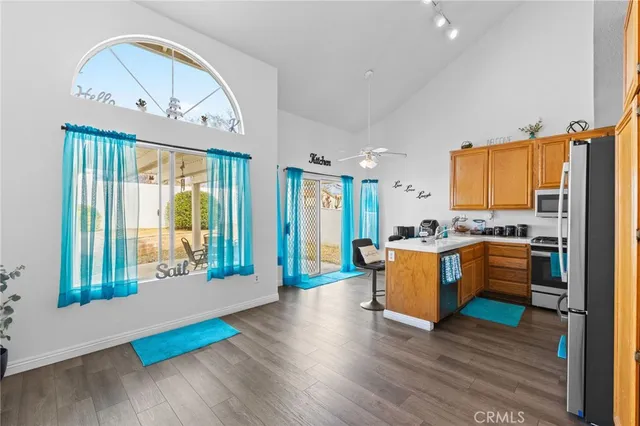 a large kitchen with kitchen island wooden floors and stainless steel appliances