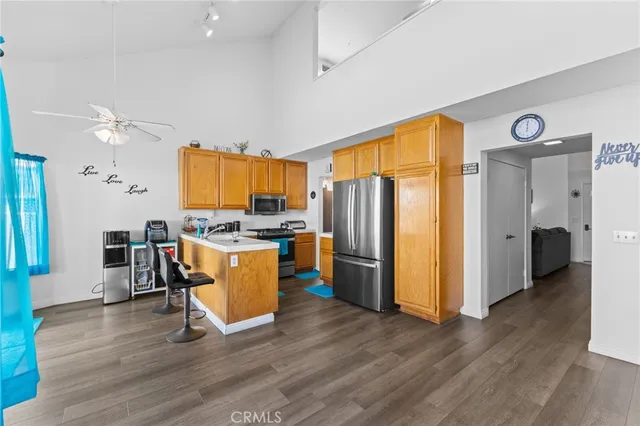 a kitchen with stainless steel appliances granite countertop a refrigerator and a stove top oven
