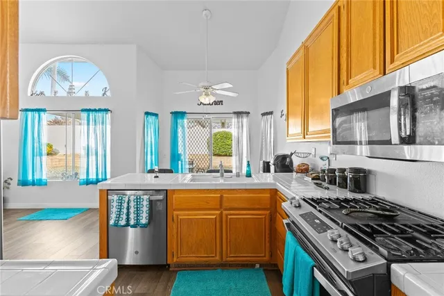 a kitchen with a stove a sink and a window