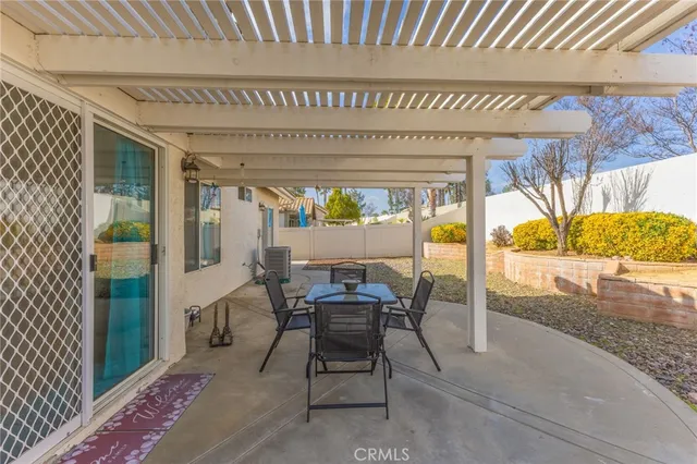a view of a patio with table and chairs and potted plants