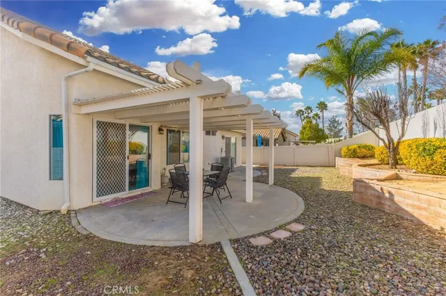 a view of a house with backyard and sitting area