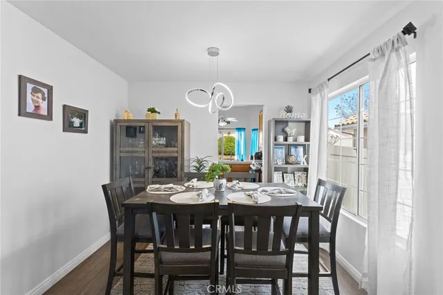 a view of a dining room with furniture and a window