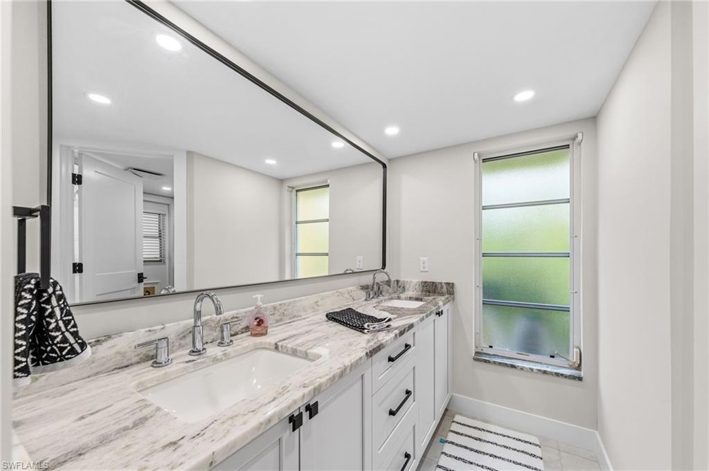 4724 Riverside Drive Estero, FL 33928 - Photo 22 of 44 a bathroom with a double vanity sink and a mirror