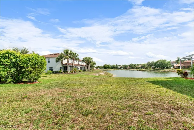 a view of a lake with houses in the back