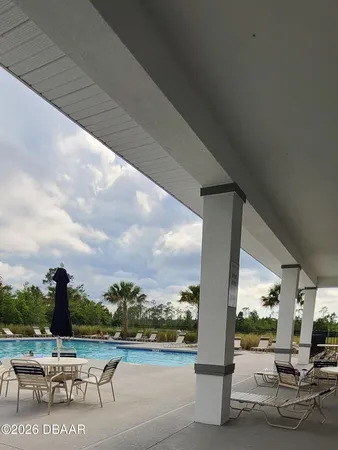 a view of swimming pool with outdoor seating and city view