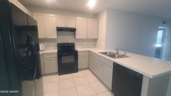 a kitchen with a sink cabinets and stainless steel appliances