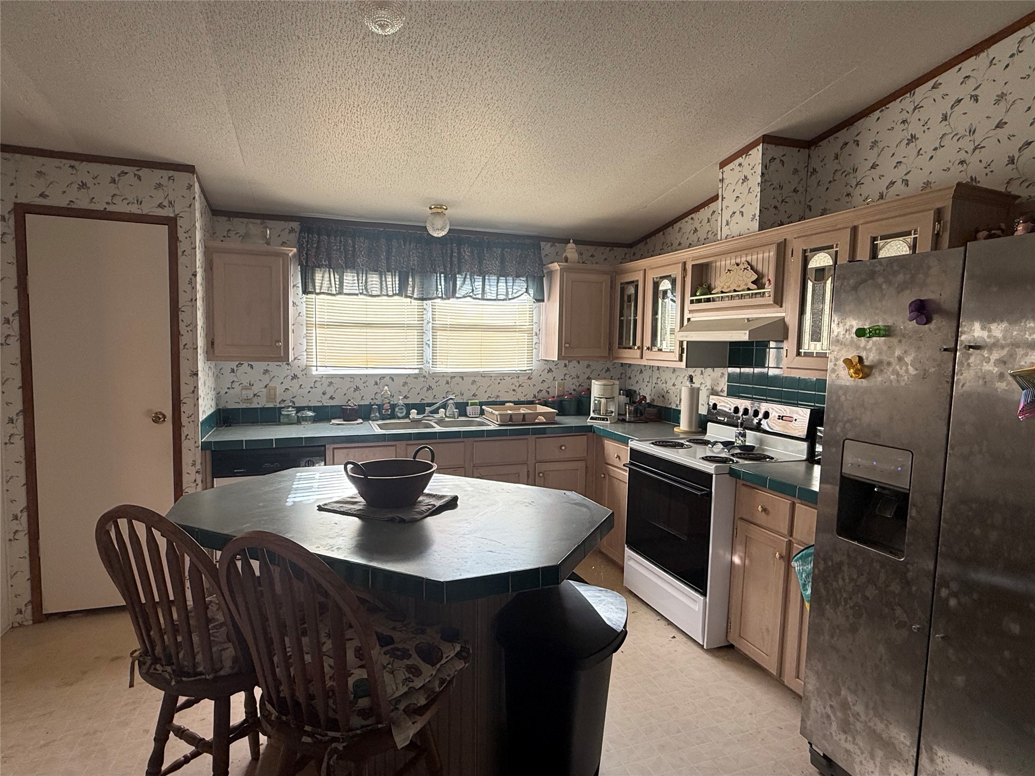 305 Canadian Drive Trinity, TX 75862 - Photo 14 of 29 a kitchen with stainless steel appliances granite countertop a sink a stove a refrigerator dining table and chairs