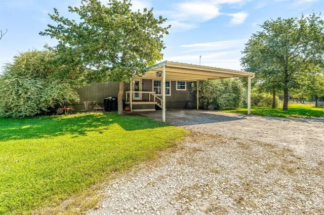 a view of a house with a yard porch and sitting area
