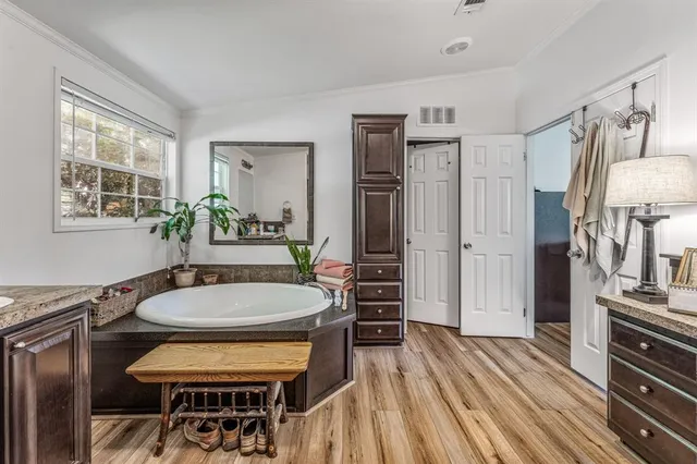 a dining room with wooden floor and furniture