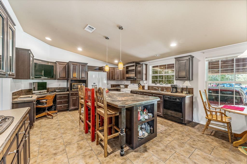 1071 Grimes Road Mineral Wells, TX 76067 - Photo 2 of 25 a kitchen with stainless steel appliances granite countertop a stove and a refrigerator