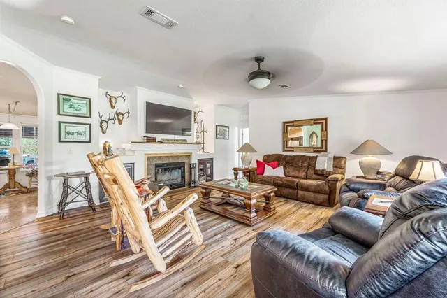 a living room with fireplace furniture and a flat screen tv