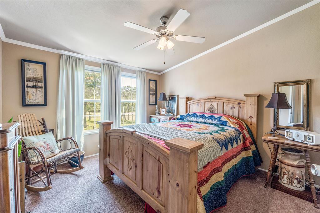 1071 Grimes Road Mineral Wells, TX 76067 - Photo 7 of 25 a bedroom with a bed a couch and a chandelier