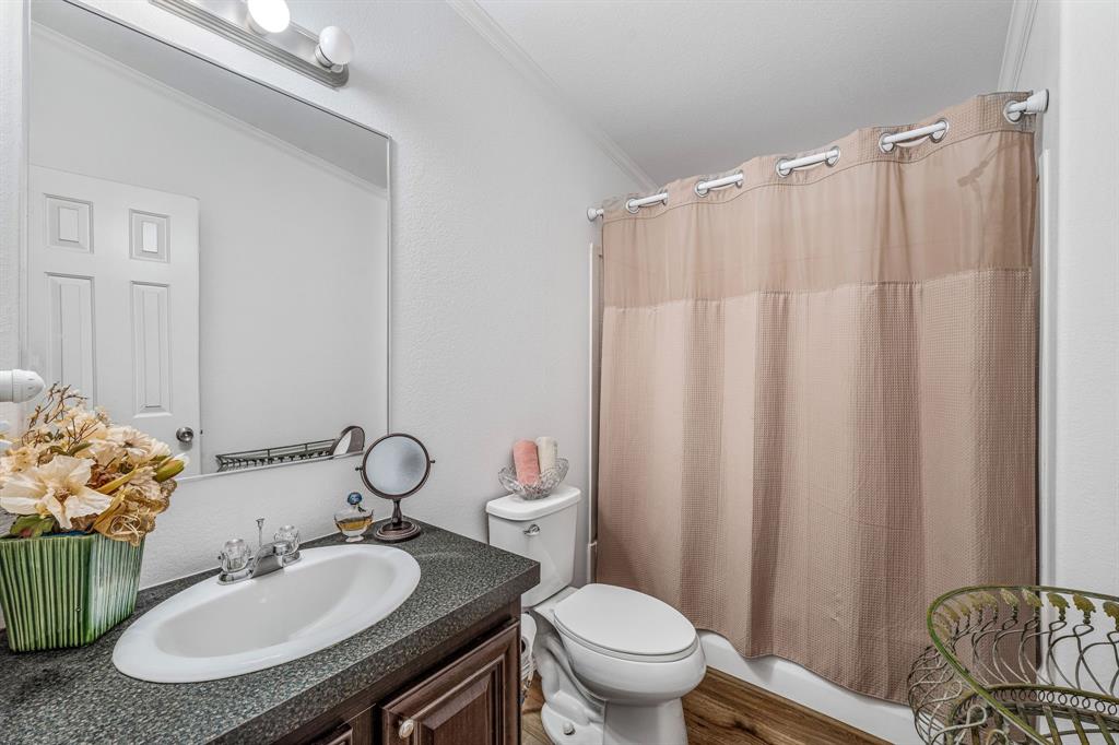 1071 Grimes Road Mineral Wells, TX 76067 - Photo 8 of 25 a bathroom with a sink toilet and a mirror