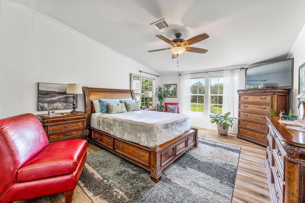 1071 Grimes Road Mineral Wells, TX 76067 - Photo 10 of 25 a bedroom with a bed and a couch