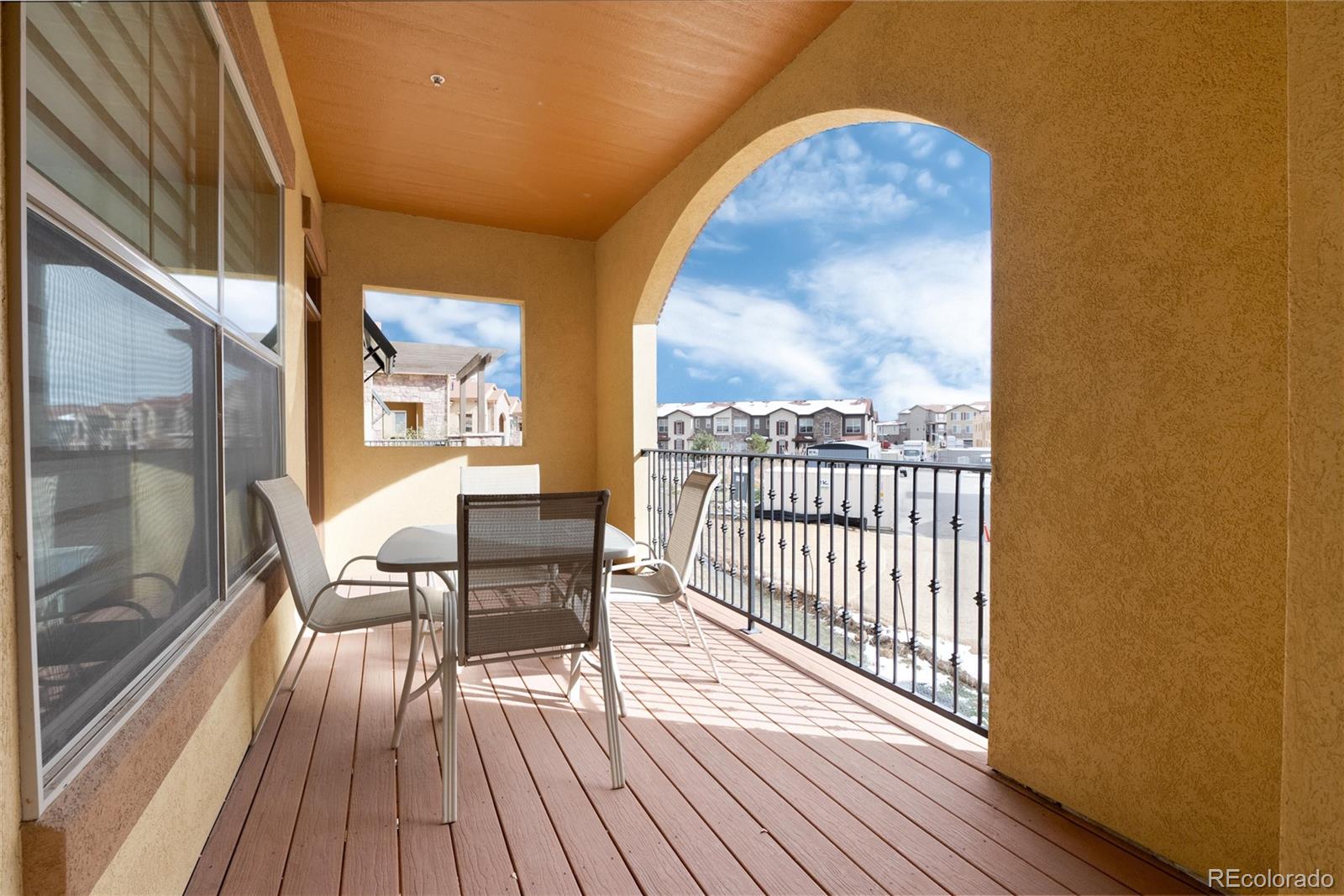 2366 Primo Road, Unit 203 Highlands Ranch, CO 80129 - Photo 17 of 35 a view of a balcony with furniture and wooden floor