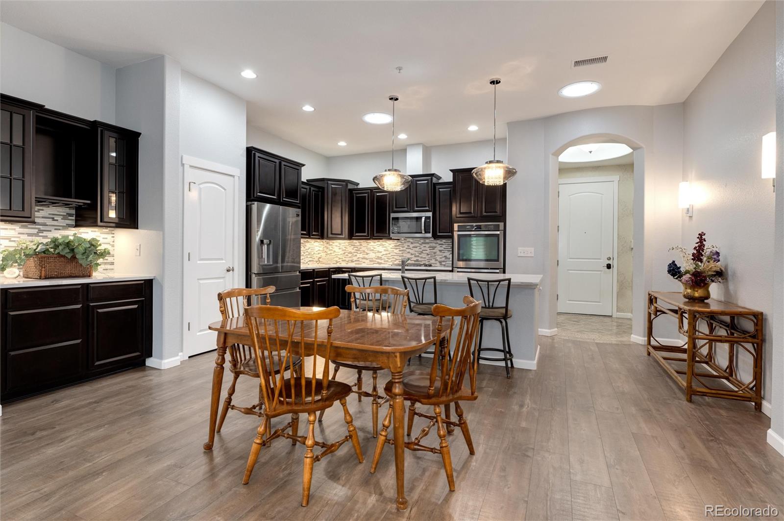 2366 Primo Road, Unit 203 Highlands Ranch, CO 80129 - Photo 19 of 35 a view of kitchen with cabinets and wooden floor