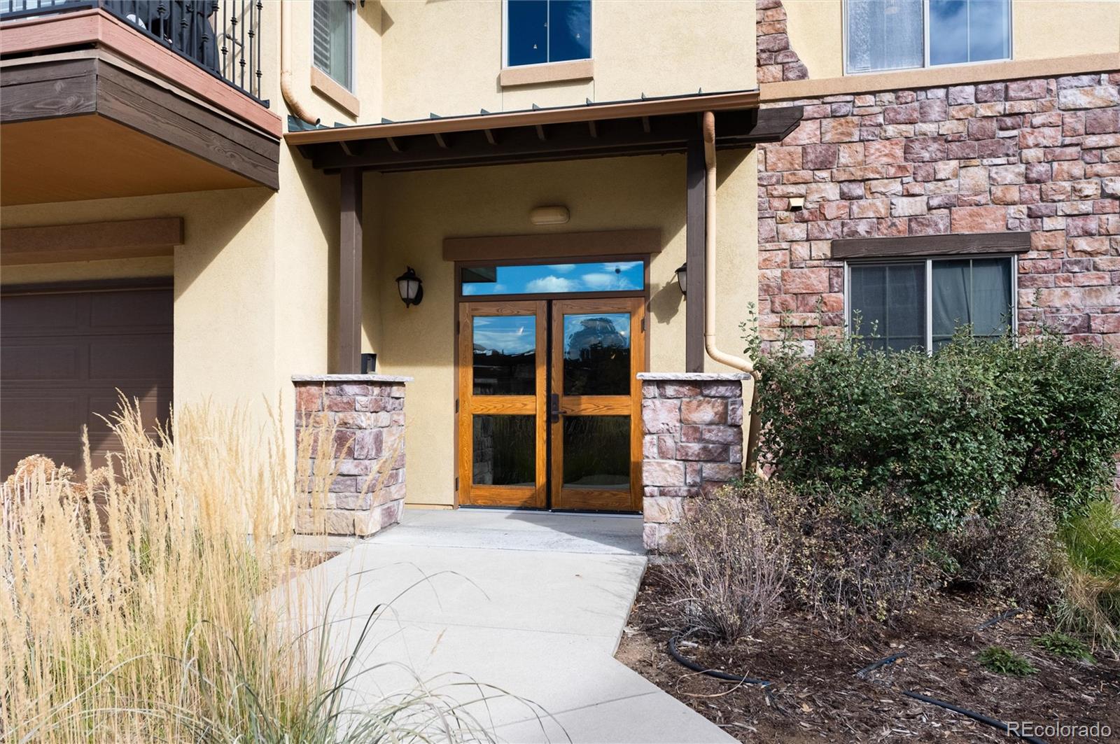 2366 Primo Road, Unit 203 Highlands Ranch, CO 80129 - Photo 4 of 35 a front view of a house with a yard