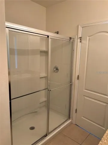 a bathroom with a glass shower door