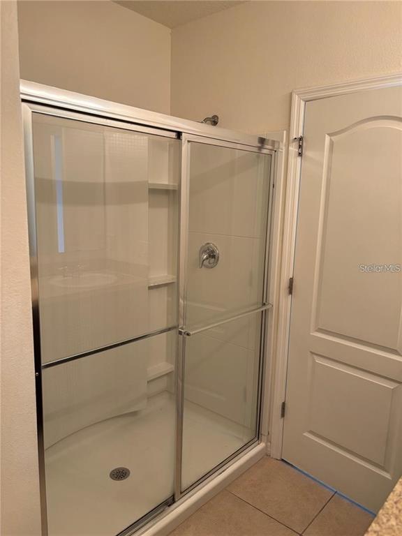 268 Arbor Lakes Drive Davenport, FL 33896 - Photo 11 of 26 a bathroom with a glass shower door