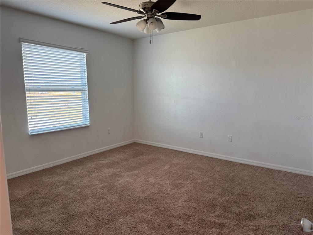 268 Arbor Lakes Drive Davenport, FL 33896 - Photo 15 of 26 an empty room with a window and a fan