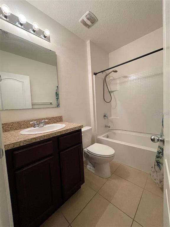 268 Arbor Lakes Drive Davenport, FL 33896 - Photo 16 of 26 a bathroom with a granite countertop bathtub shower sink vanity and toilet