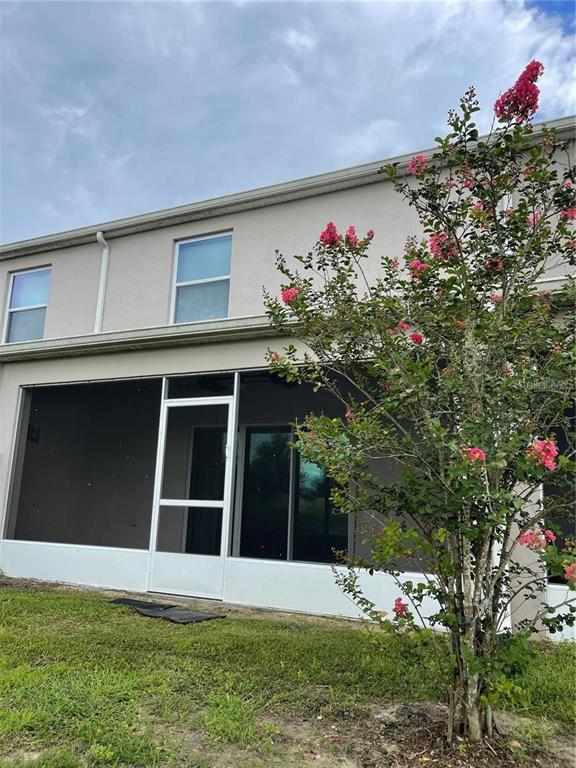 268 Arbor Lakes Drive Davenport, FL 33896 - Photo 19 of 26 a house view with a garden space