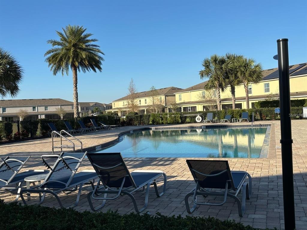 268 Arbor Lakes Drive Davenport, FL 33896 - Photo 22 of 26 a view of a lake with table and chairs