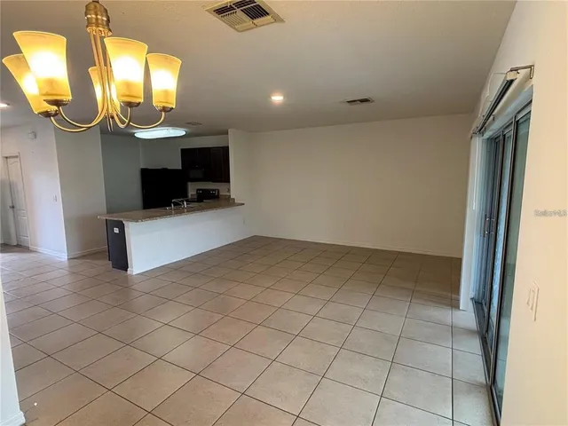 en empty room with mirror and fan