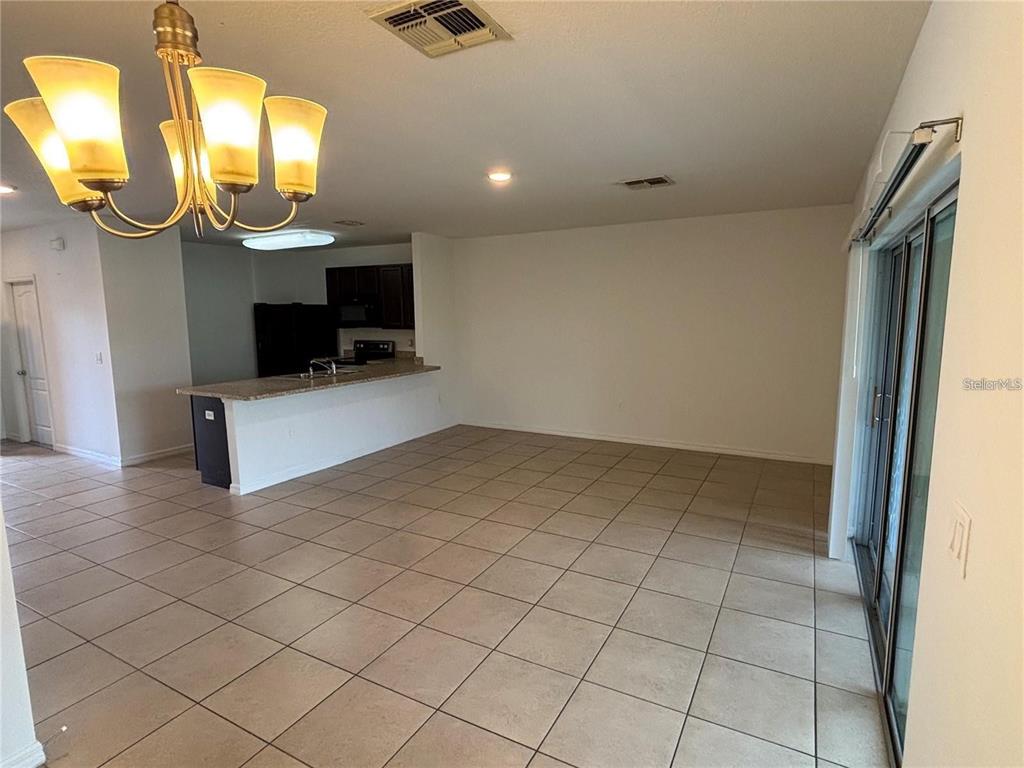 268 Arbor Lakes Drive Davenport, FL 33896 - Photo 5 of 26 en empty room with mirror and fan