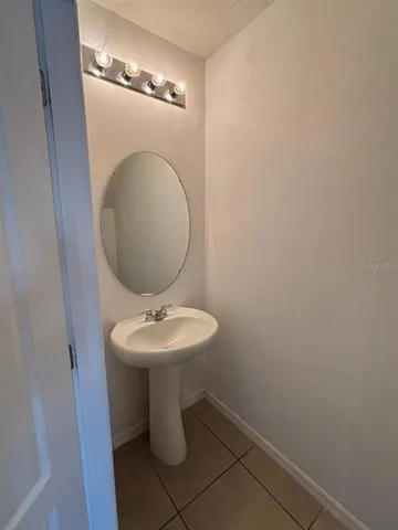a bathroom with a sink and mirror