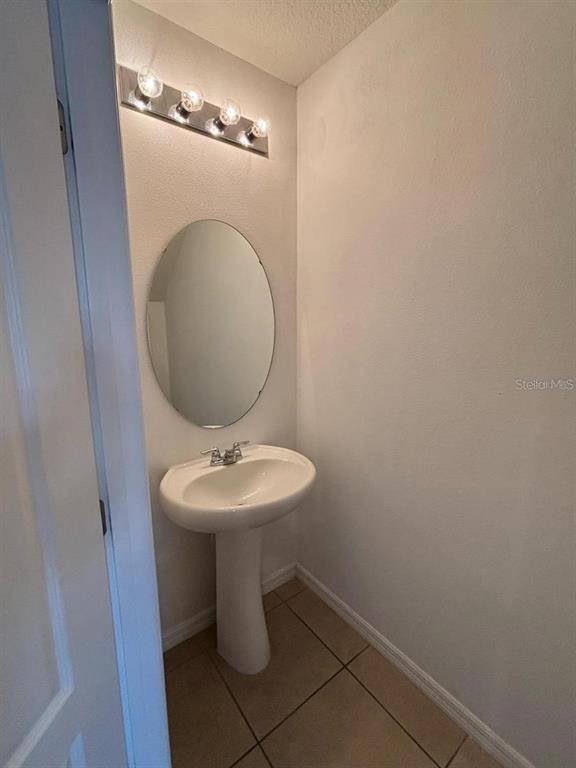 268 Arbor Lakes Drive Davenport, FL 33896 - Photo 8 of 26 a bathroom with a sink and mirror