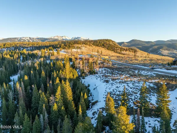 a view of a house with a yard and mountain